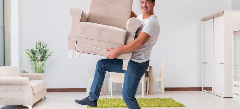 Man arranging furniture in his new home after a house move