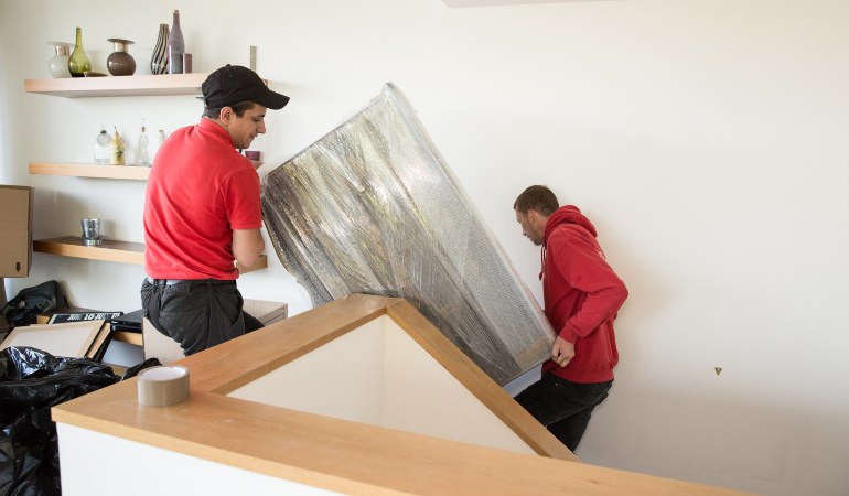 Removals team moving a fridge