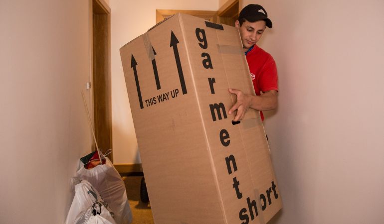 Professional mover handling a heavy moving box