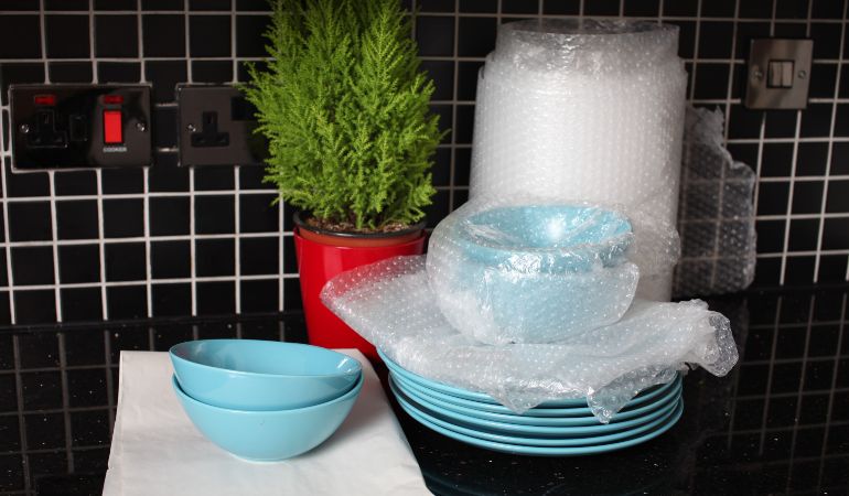 Bowls and plates safely packed with bubble wrap