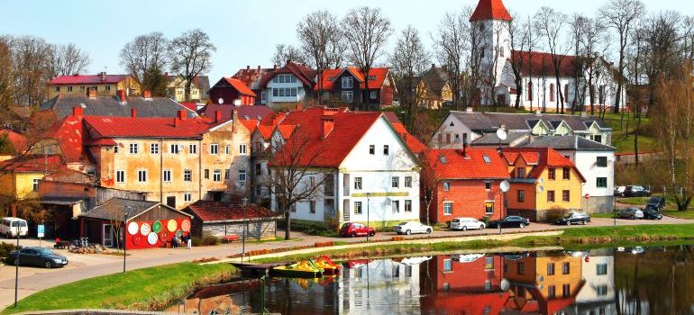 Colorful old town houses and church with lake reflection in spring morning in Talsi Latvia