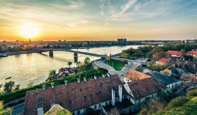 Cityscape of Novi Sad on the Danube River at sunset