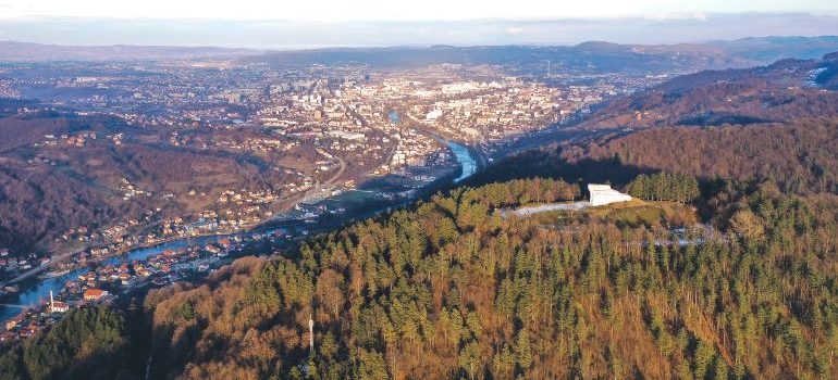 Aerial view of the monument Šehitluci and the forests over Banja Luka, Bosnia and Herzegovina
