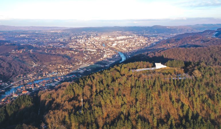 Aerial view of the monument Šehitluci and the forests over Banja Luka, Bosnia and Herzegovina