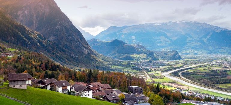 Scenic aerial view of hillside villages in Triesenberg and the river Rhine, natural border of Liechtenstein, an alpine country in central Europe
