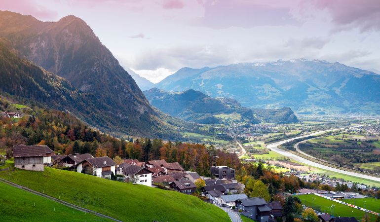 Scenic aerial view of hillside villages in Triesenberg and the river Rhine, natural border of Liechtenstein, an alpine country in central Europe