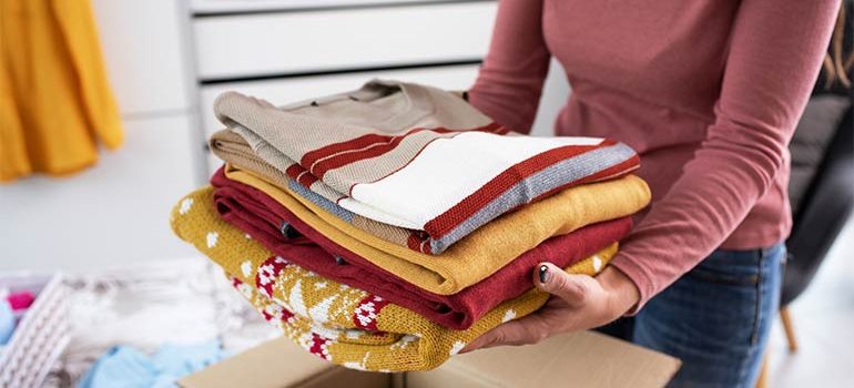 Packing Clothes in a Box for a Move