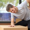 Man with back pain after lifting heavy object