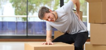 Man with back pain after lifting heavy object