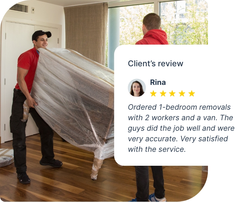 The image shows two movers who wear Fantastic Removals work uniforms that are moving furniture.